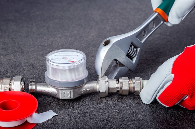 Meter replacement plumber-installing-water-meter-plumber-wrenches-repairing-pipes